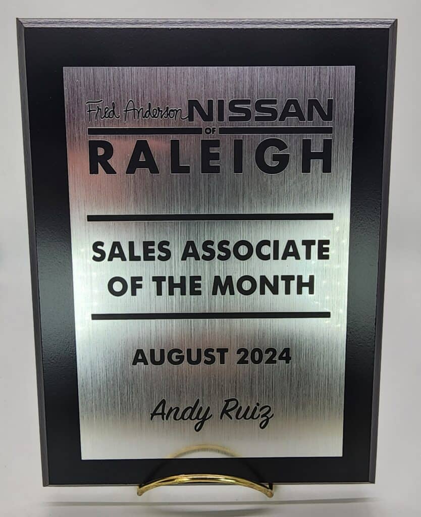 A plaque from Fred Anderson Nissan of Raleigh recognizing &quot;Sales Associate of the Month&quot; for August 2024 awarded to Andy Ruiz.