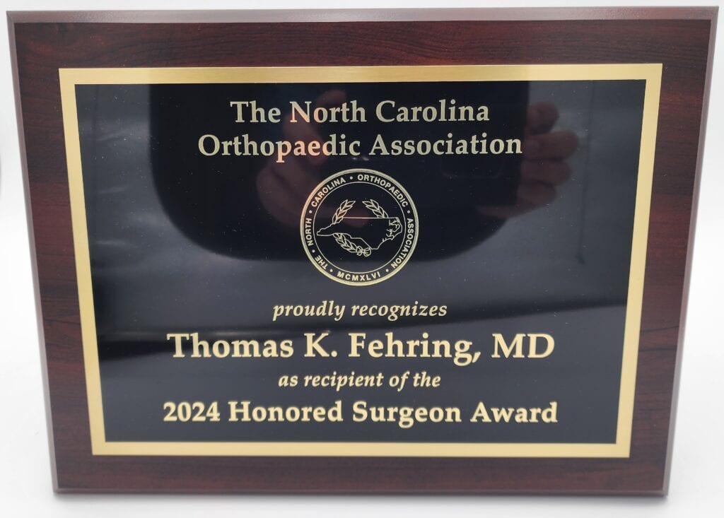 A recognition plaque from the North Carolina Orthopaedic Association, awarded to Thomas K. Fehring, MD, as the recipient of the 2024 Honored Surgeon Award.