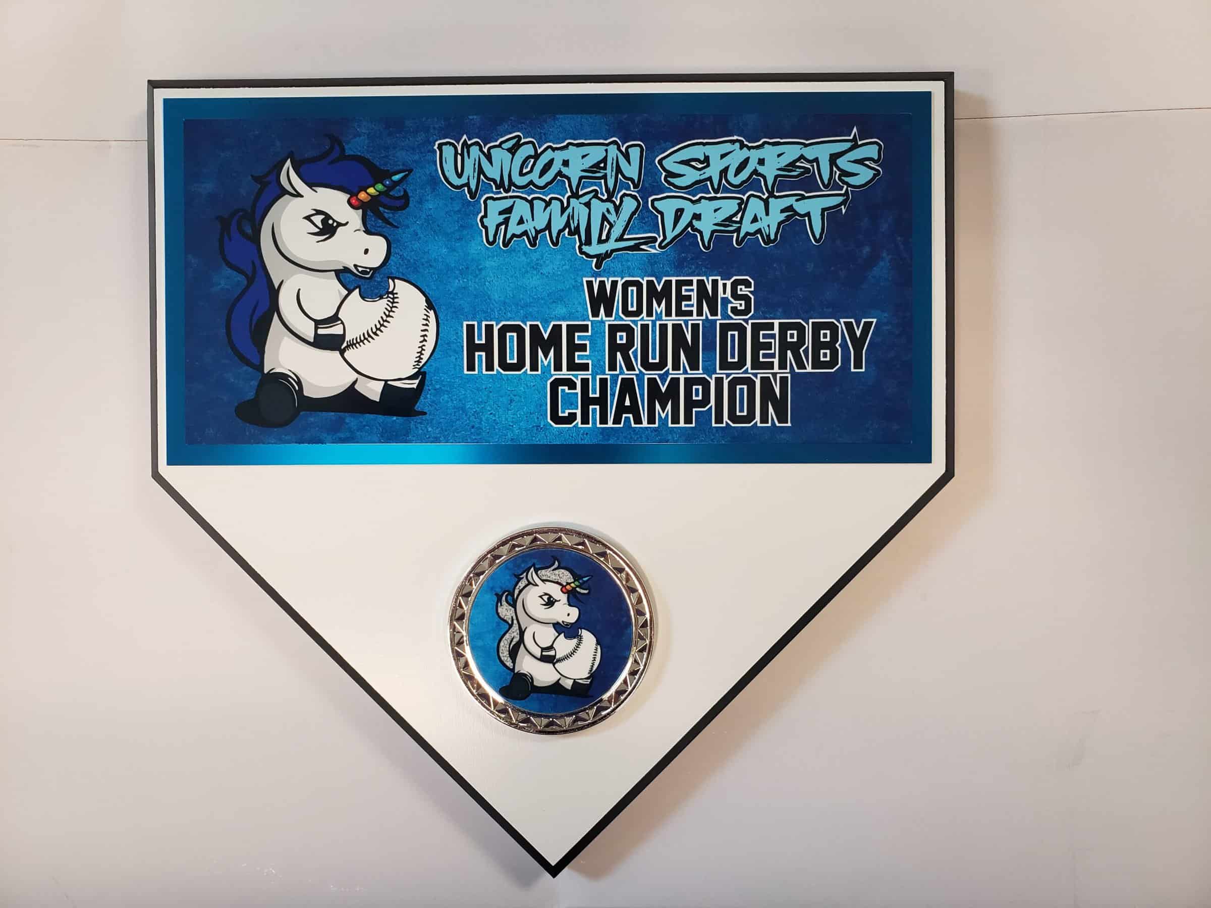A plaque shaped like a baseball home plate featuring a cartoon unicorn holding a baseball, with text that reads "Unicorn Sports Family Draft Women's Home Run Derby Champion."