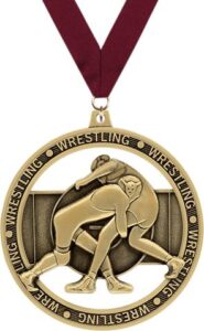 A gold wrestling medal featuring two wrestlers in a grappling pose, surrounded by the word 'WRESTLING' repeated along the rim. The medal is attached to a red ribbon.