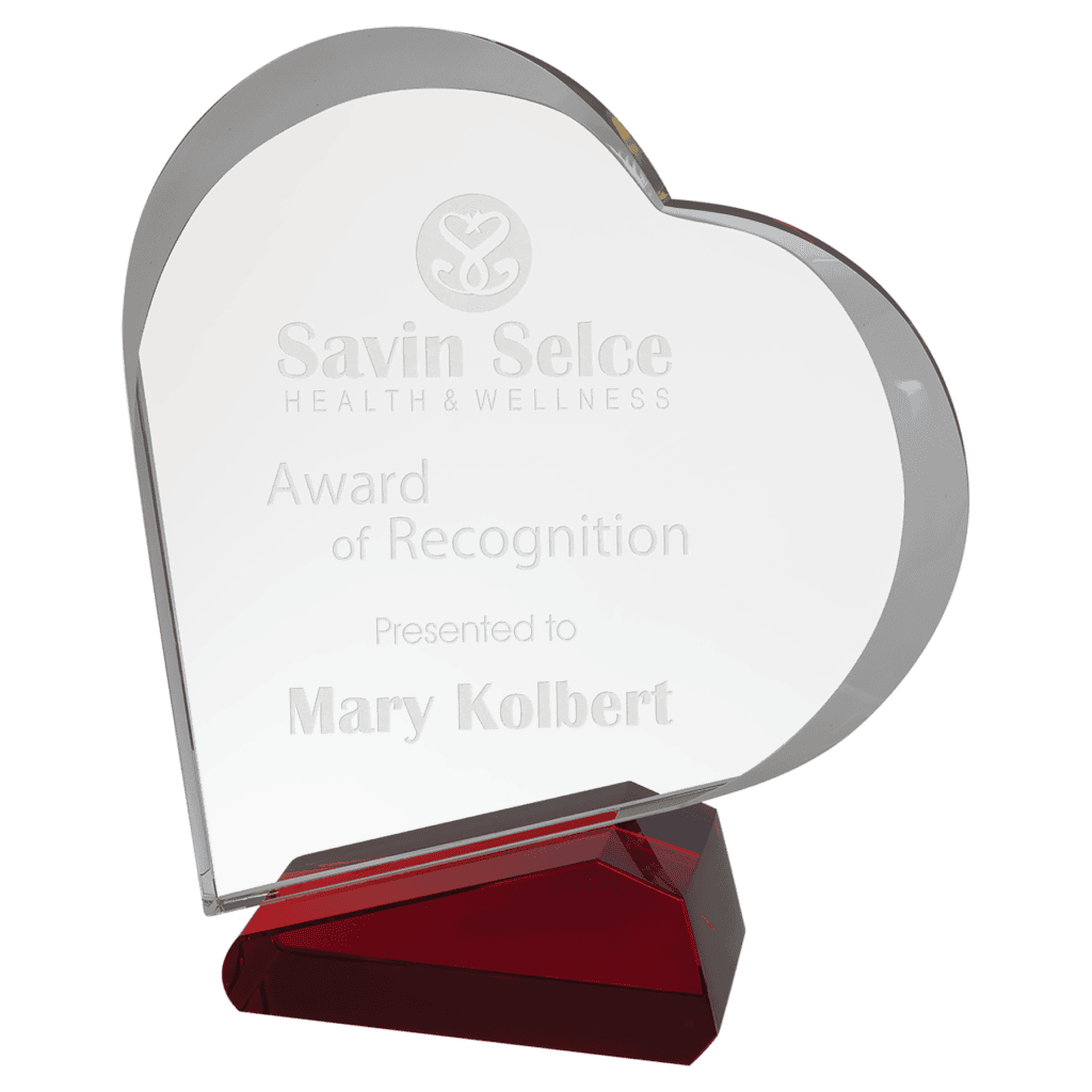 Heart-shaped glass award with text "Savin Selce Health &amp; Wellness, Award of Recognition, Presented to Mary Kolbert," mounted on a red base.