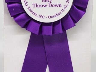 A purple award ribbon for 8th place in a pork category at the Eastern Carolina BBQ Throw Down in Rocky Mount, NC, dated October 11-12, 2024.