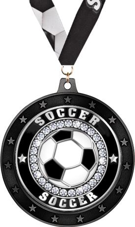 A soccer-themed medal featuring a black and white soccer ball in the center, surrounded by a ring of decorative stones and the word 'SOCCER' repeated twice, with a black ribbon attached.