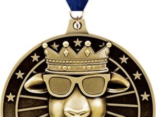 Gold-toned medal with a depiction of a goat wearing a crown and sunglasses, and the acronym 'GOAT' below, attached to a dark blue ribbon.