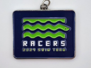 A rectangular custom medal with a navy blue background and wavy green lines, featuring the text 'RACERS 2024 SWIM TEAM' in white and green lettering.
