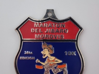 A custom medal featuring a red and blue design with the text 'Maraton Del Jibaro Morovis' and '36ta Edicion 10K'. It also includes an illustration of a runner.