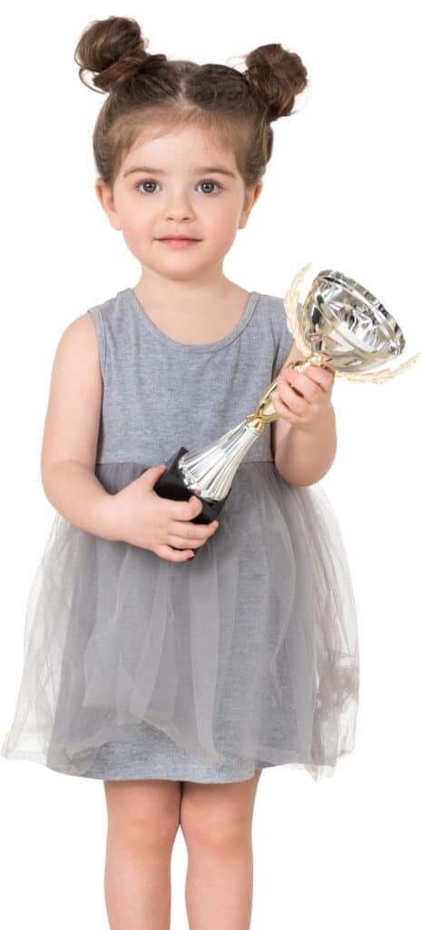 a little girl in a gray dress holding a fan