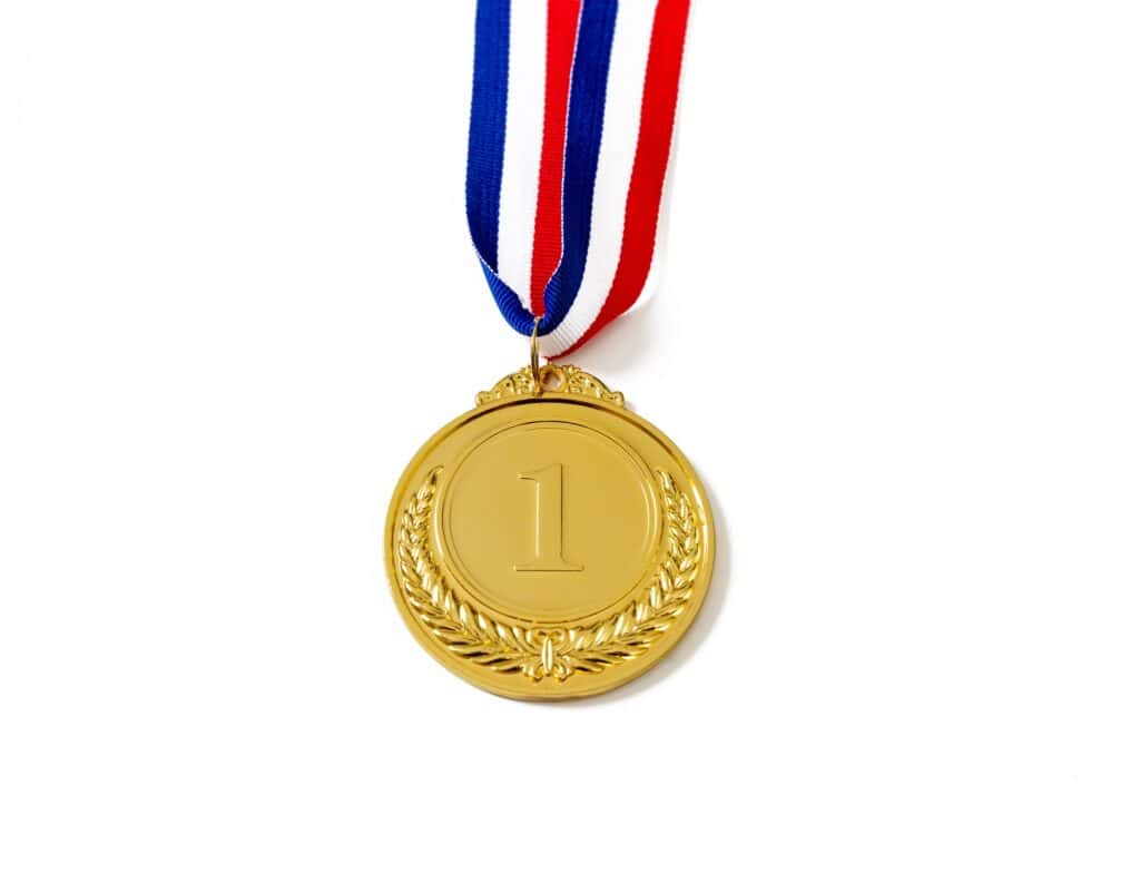 Gold medal. Champion trophy award and ribbon. Prize in sport for winner isolated on white background