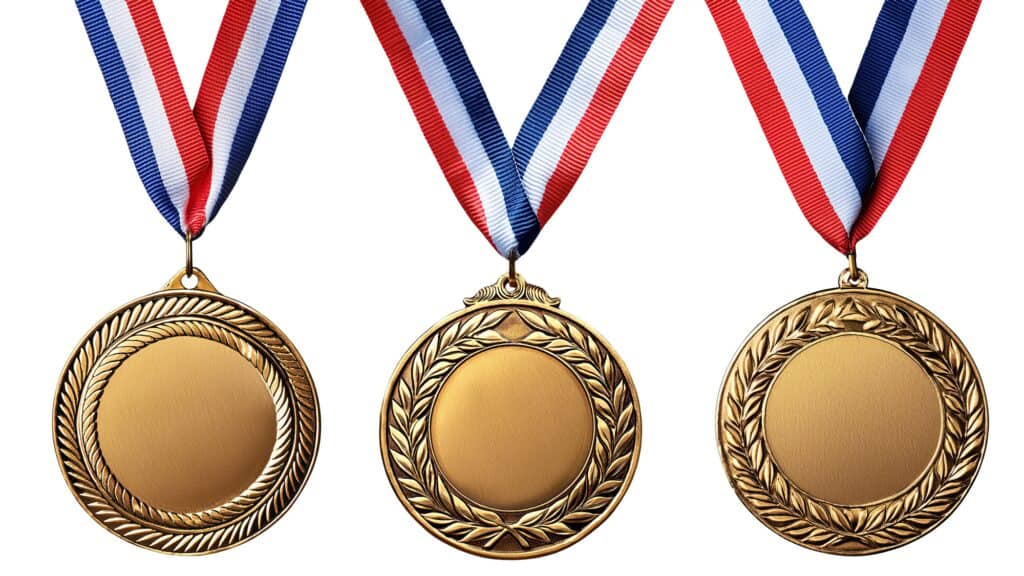 Gold medals with red, white, and blue ribbons arranged in a row against a white background.